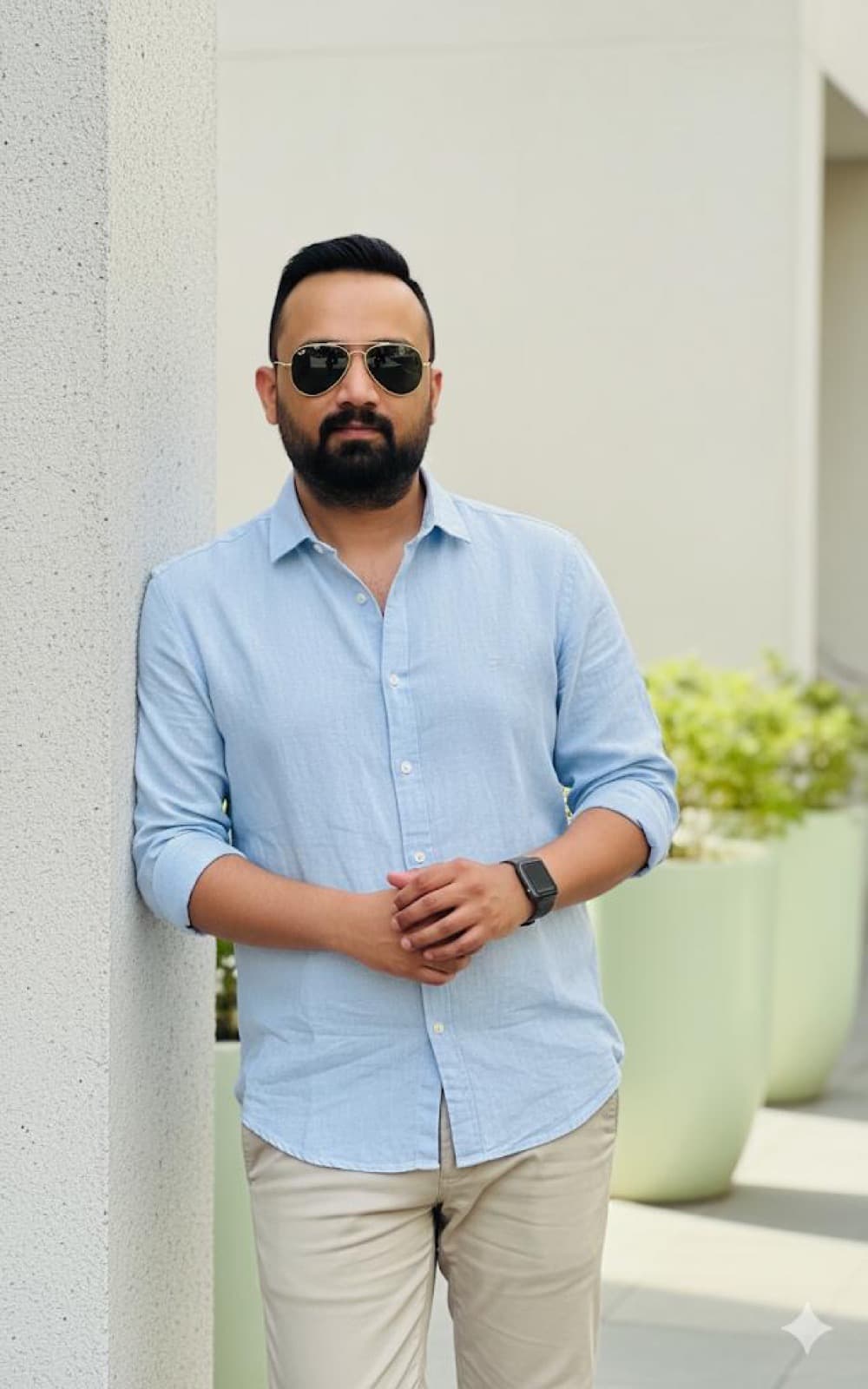 Portrait of Hasan Ali, the Magic Wheels driving instructor, in a light blue shirt.